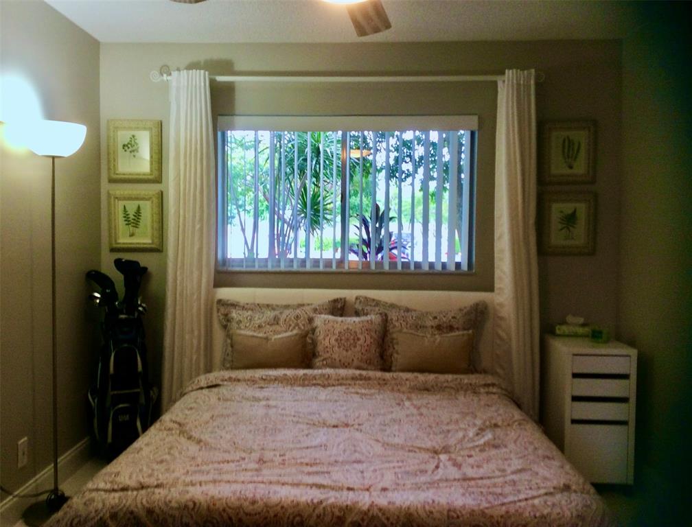 Undisclosed Address Pompano Beach, FL 33069 - Photo 9 of 23 a bedroom with a bed and a window