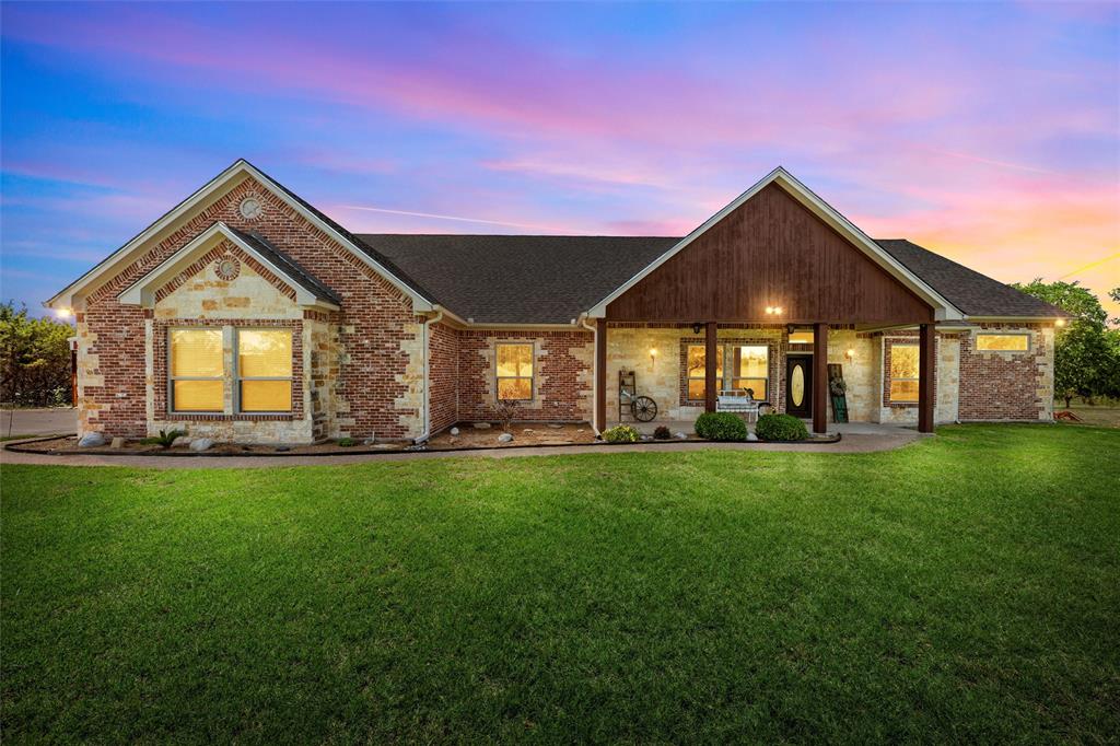 1527 Old Ranch Road China Spring, TX 76633 - Photo 1 of 1 View of front of home featuring a front yard, brick siding, a shingled roof, and stone siding