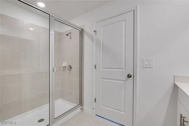a bathroom with a glass shower door
