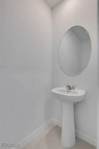 a bathroom with a sink and mirror