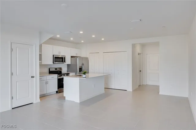a kitchen with stainless steel appliances a refrigerator sink and stove