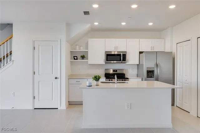a kitchen with cabinets and stainless steel appliances