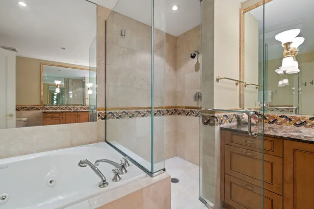 a bathroom with a sink a toilet a mirror and shower