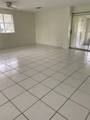 a view of an empty room and a window