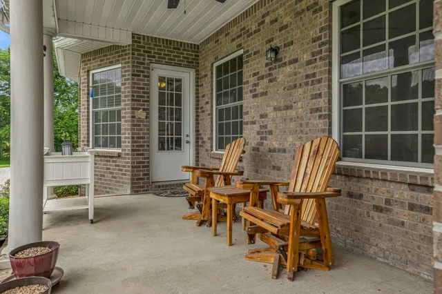 a living room with furniture a wooden floor and a window