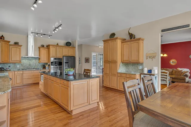 a spacious bathroom with a granite countertop tub sink and mirror