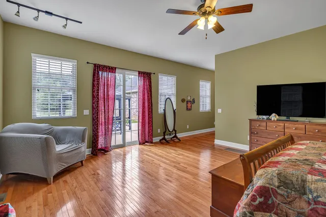 a view of an empty room with cabinet and chandelier fan