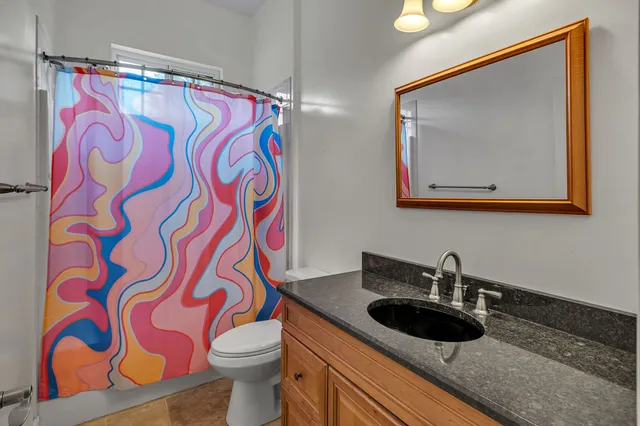 a view of a house with a big yard plants and large trees