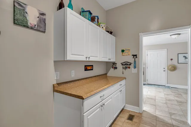 a view of a chair and table on the green field