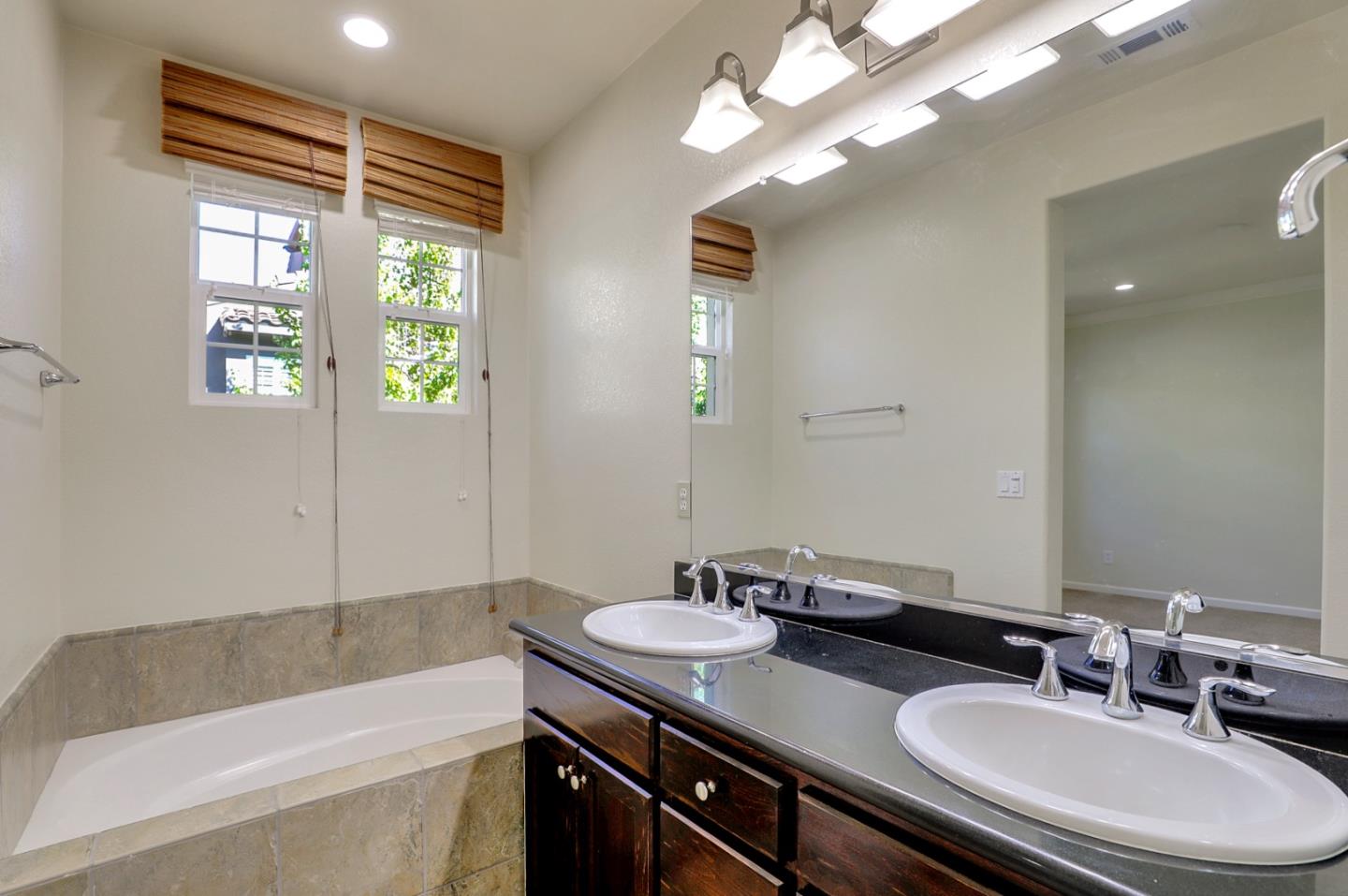 5090 Fioli Loop San Ramon, CA 94582 - Photo 26 of 36 a bathroom with a granite countertop sink and a bathtub