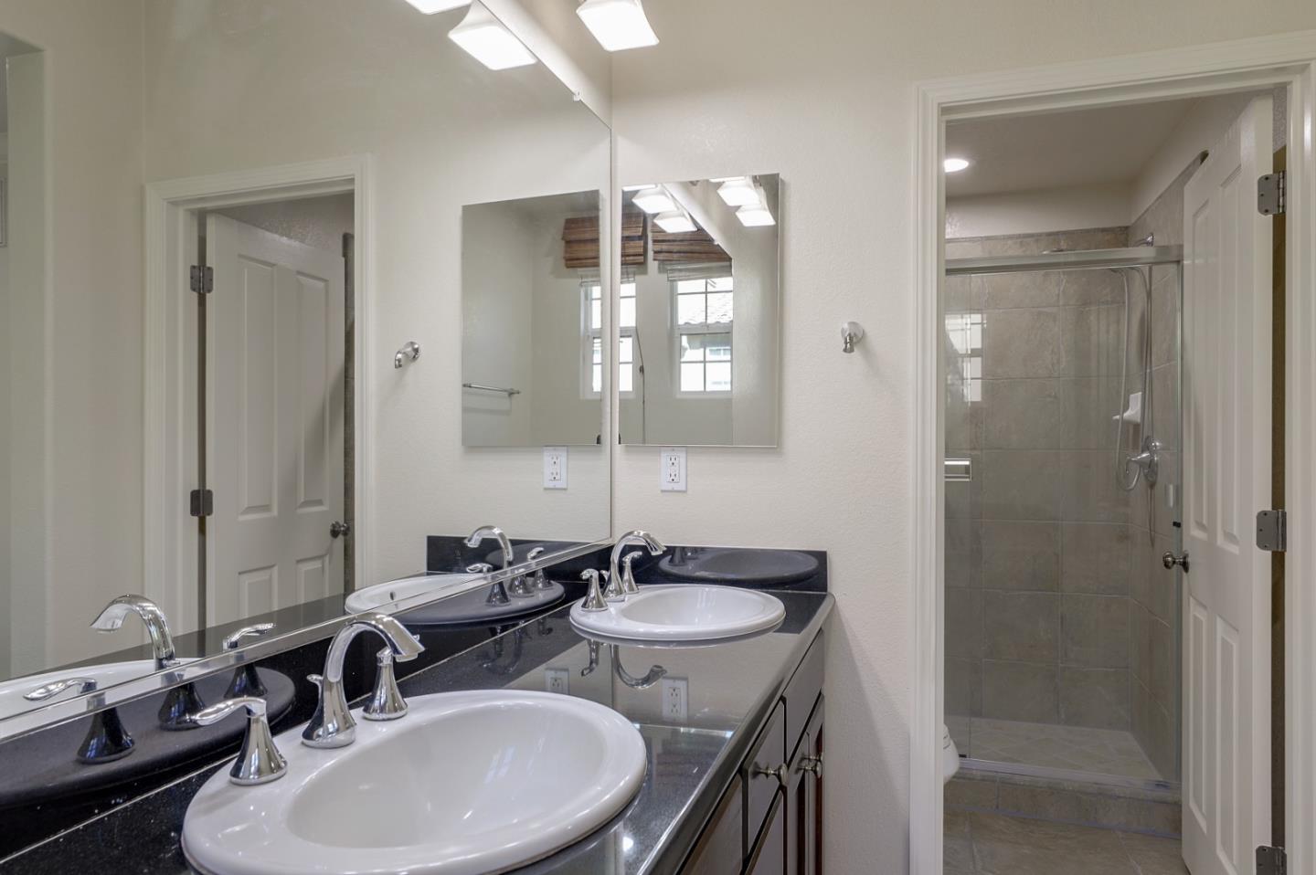 5090 Fioli Loop San Ramon, CA 94582 - Photo 27 of 36 a bathroom with double sink and a mirror