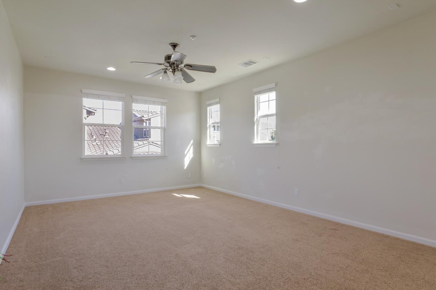 5090 Fioli Loop San Ramon, CA 94582 - Photo 30 of 36 en empty room with windows and ceiling fan