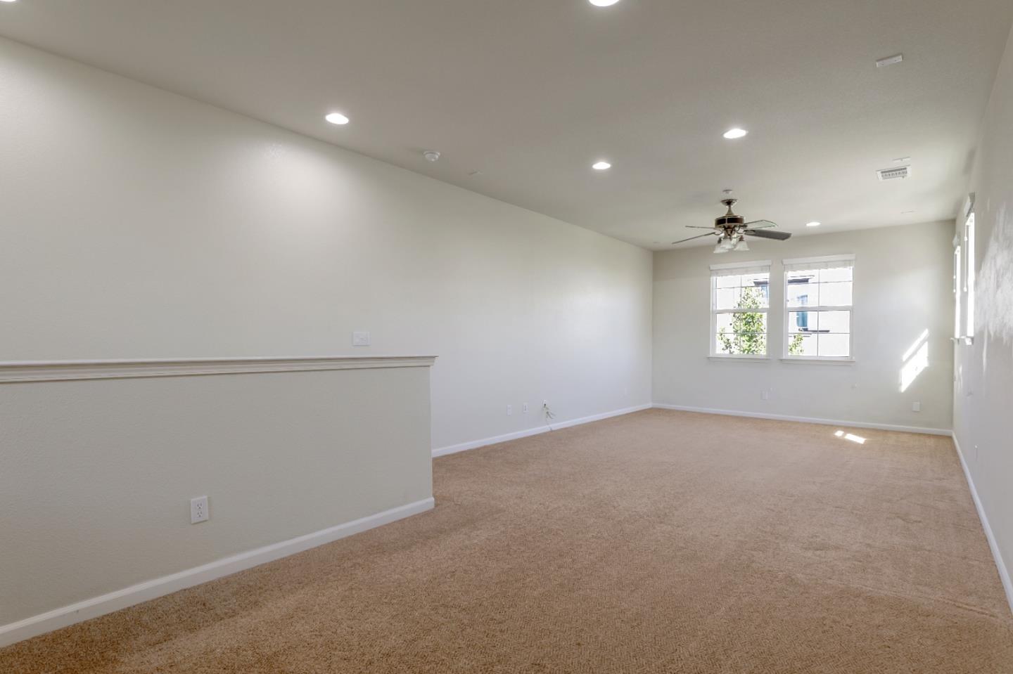 5090 Fioli Loop San Ramon, CA 94582 - Photo 31 of 36 an empty room with windows and ceiling fan