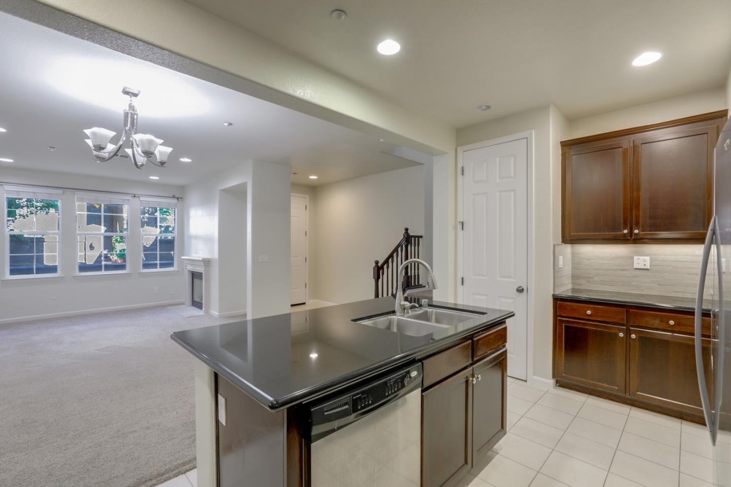 5090 Fioli Loop San Ramon, CA 94582 - Photo 7 of 36 a kitchen with stainless steel appliances granite countertop a sink counter space and cabinets