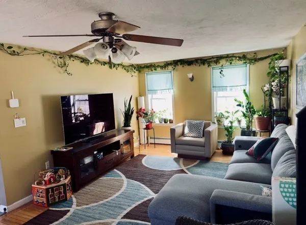 a living room with furniture and a chandelier