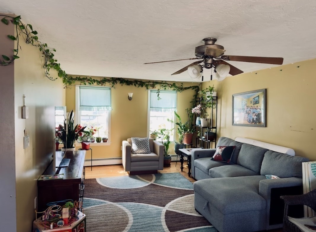 84 Chester Street Worcester, MA 01605 - Photo 14 of 21 a living room with furniture and a chandelier