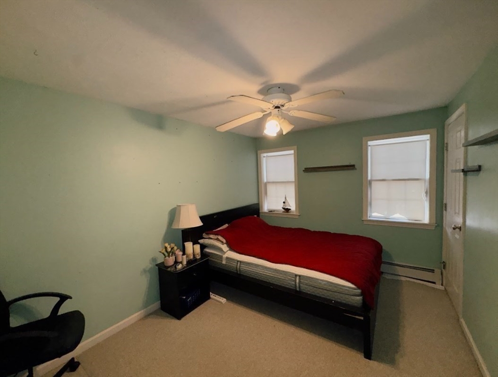 84 Chester Street Worcester, MA 01605 - Photo 20 of 21 a bedroom with a bed and a chandelier