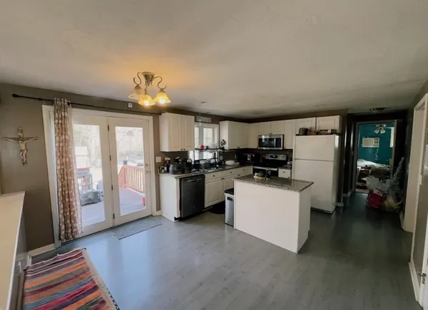 a kitchen that has a lot of cabinets and refrigerator