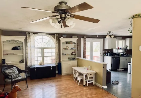 a view of a dining room with furniture window and wooden floor