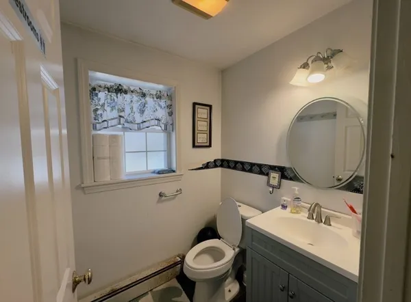 a bathroom with a toilet sink and mirror