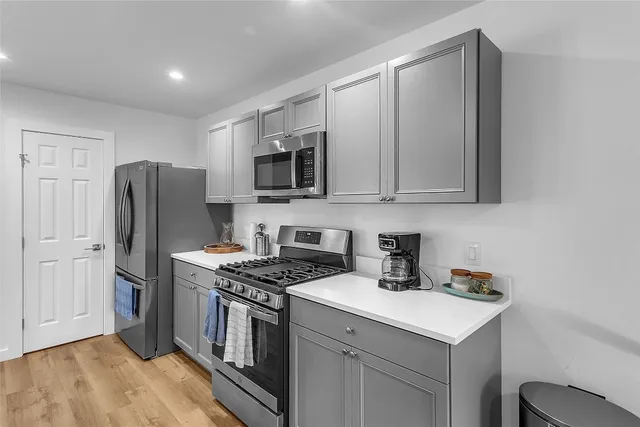 a large kitchen with kitchen island a sink table and chairs