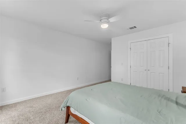 a kitchen with a table chairs a flat screen tv and a window