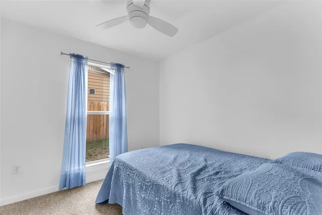 a bedroom with a bed and a lamp