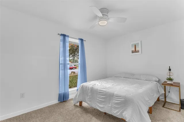 a bathroom with a granite countertop sink a toilet and a mirror