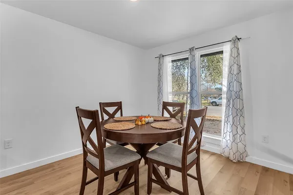 a dining room with furniture and wooden floor