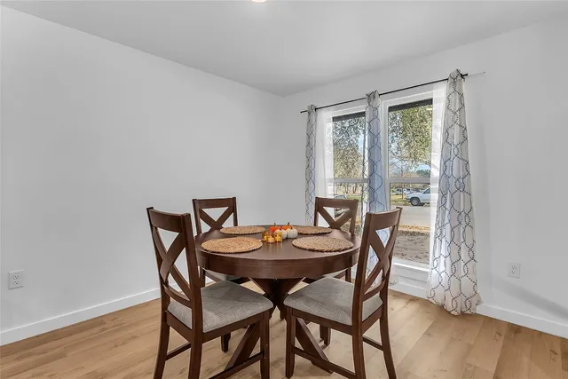 a dining room with furniture and wooden floor