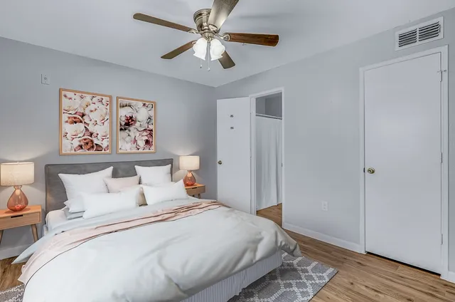 a bedroom with a large bed and a chandelier