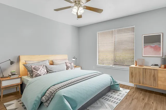 a bedroom with bed and window