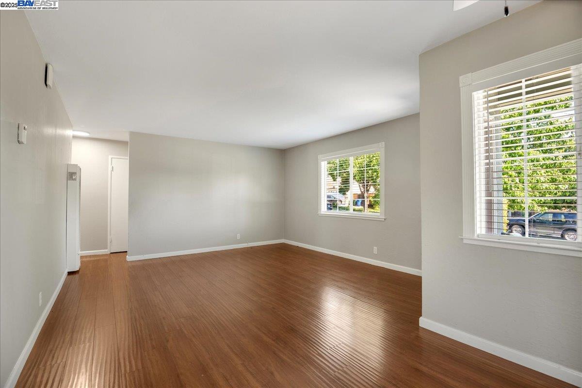 323 De Leon Avenue Fremont, CA 94539 - Photo 6 of 16 an empty room with wooden floor and windows