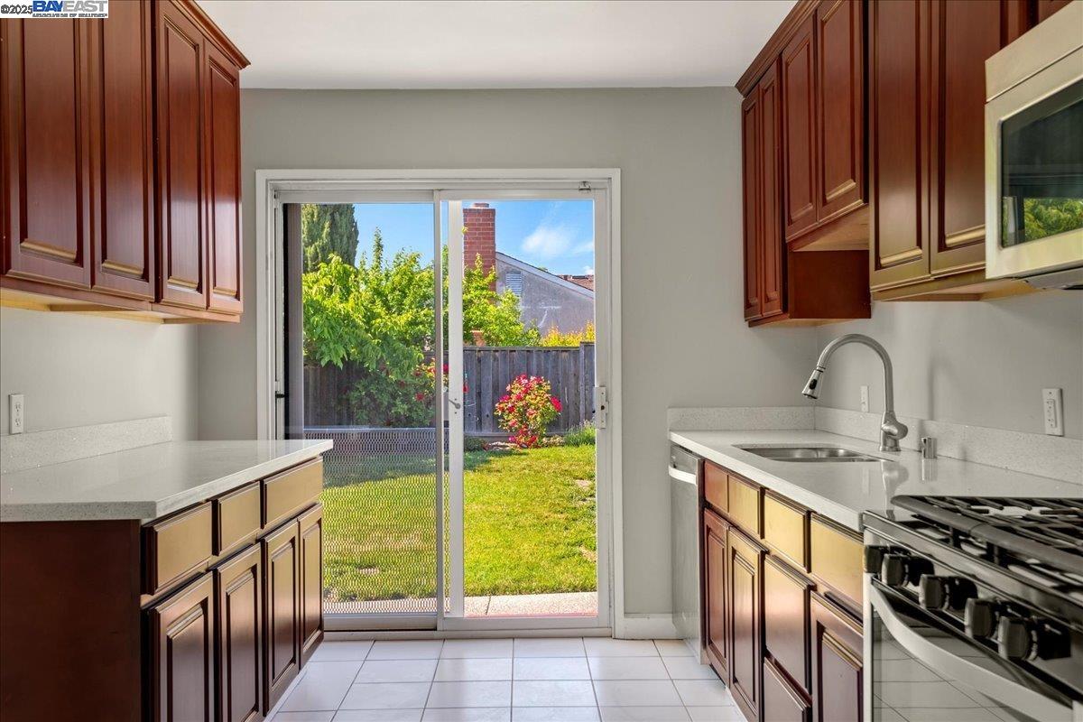 323 De Leon Avenue Fremont, CA 94539 - Photo 7 of 16 a kitchen with stainless steel appliances granite countertop a sink and a stove
