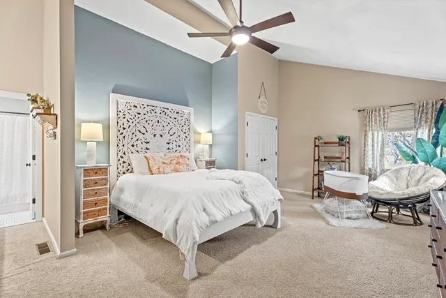 a bedroom with a bed a table and chair