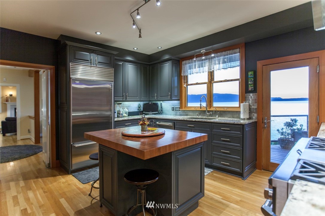 804 Fieldston Road Bellingham, WA 98225 - Photo 11 of 40 a kitchen with stainless steel appliances granite countertop a sink a stove and a refrigerator