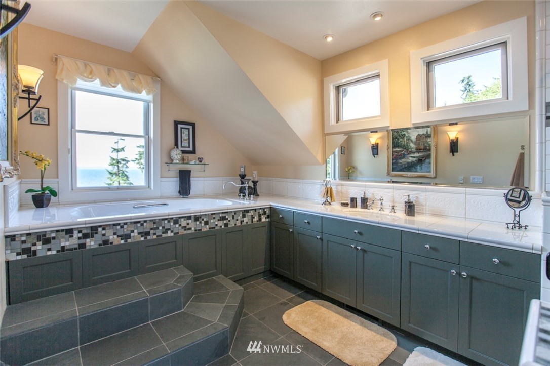 804 Fieldston Road Bellingham, WA 98225 - Photo 28 of 40 a bathroom with a granite countertop sink a mirror and a window