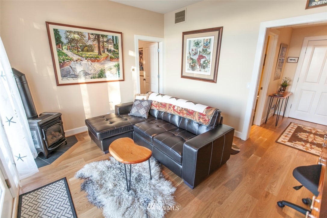 804 Fieldston Road Bellingham, WA 98225 - Photo 34 of 40 a living room with furniture a flat screen tv and a fireplace