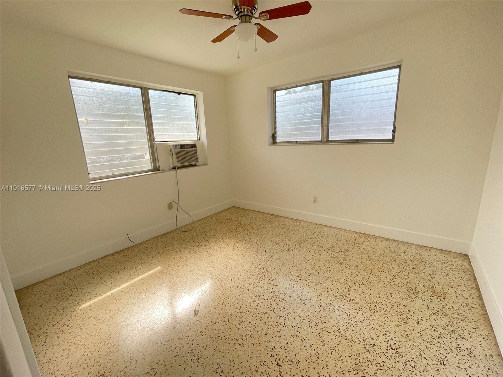 527 Southwest 10th Street, Unit 3 Miami, FL 33130 - Photo 3 of 4 an empty room with a window and a ceiling fan