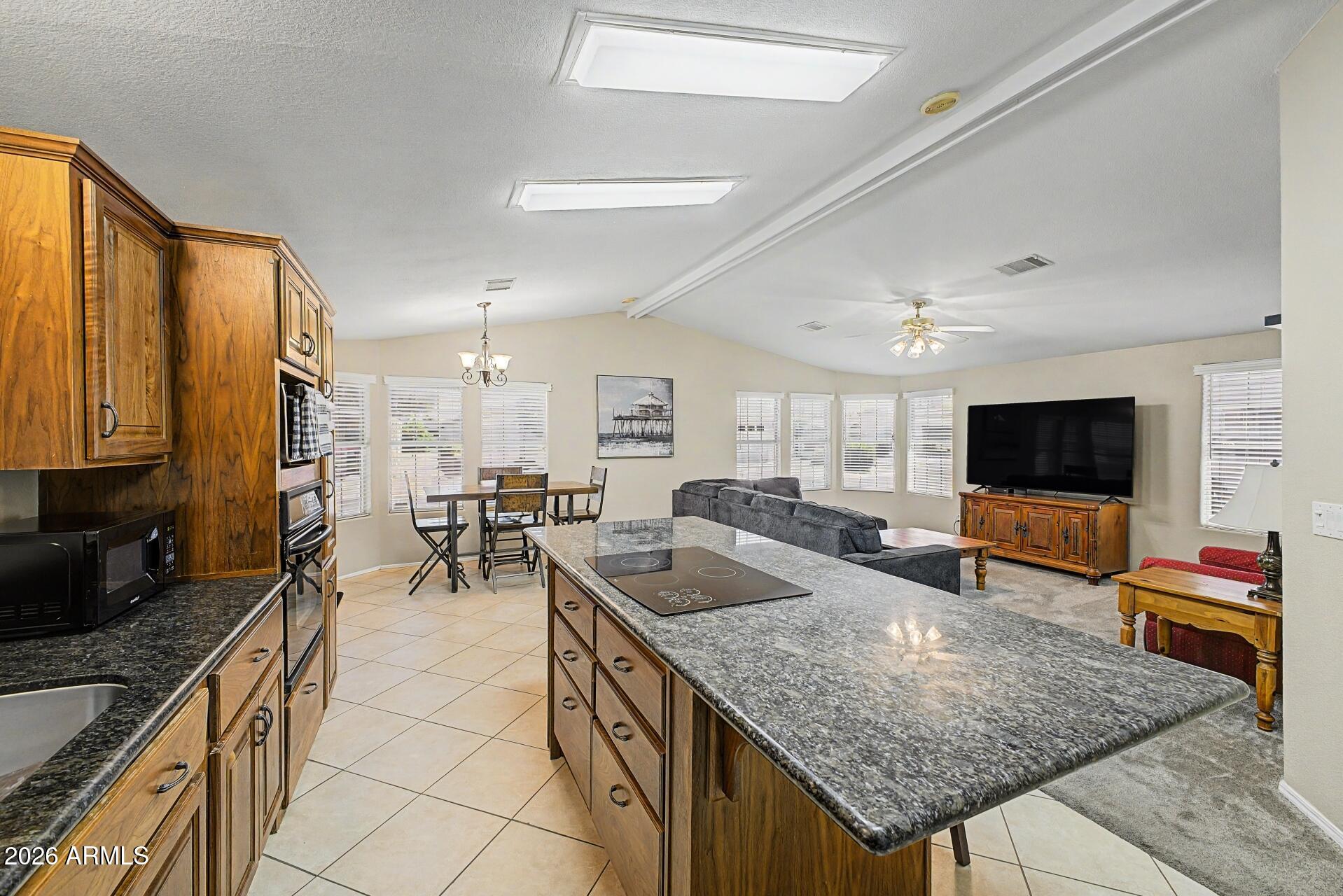 2550 South Ellsworth Road, Unit 46 Mesa, AZ 85209 - Photo 2 of 46 a kitchen with granite countertop a sink and a stove