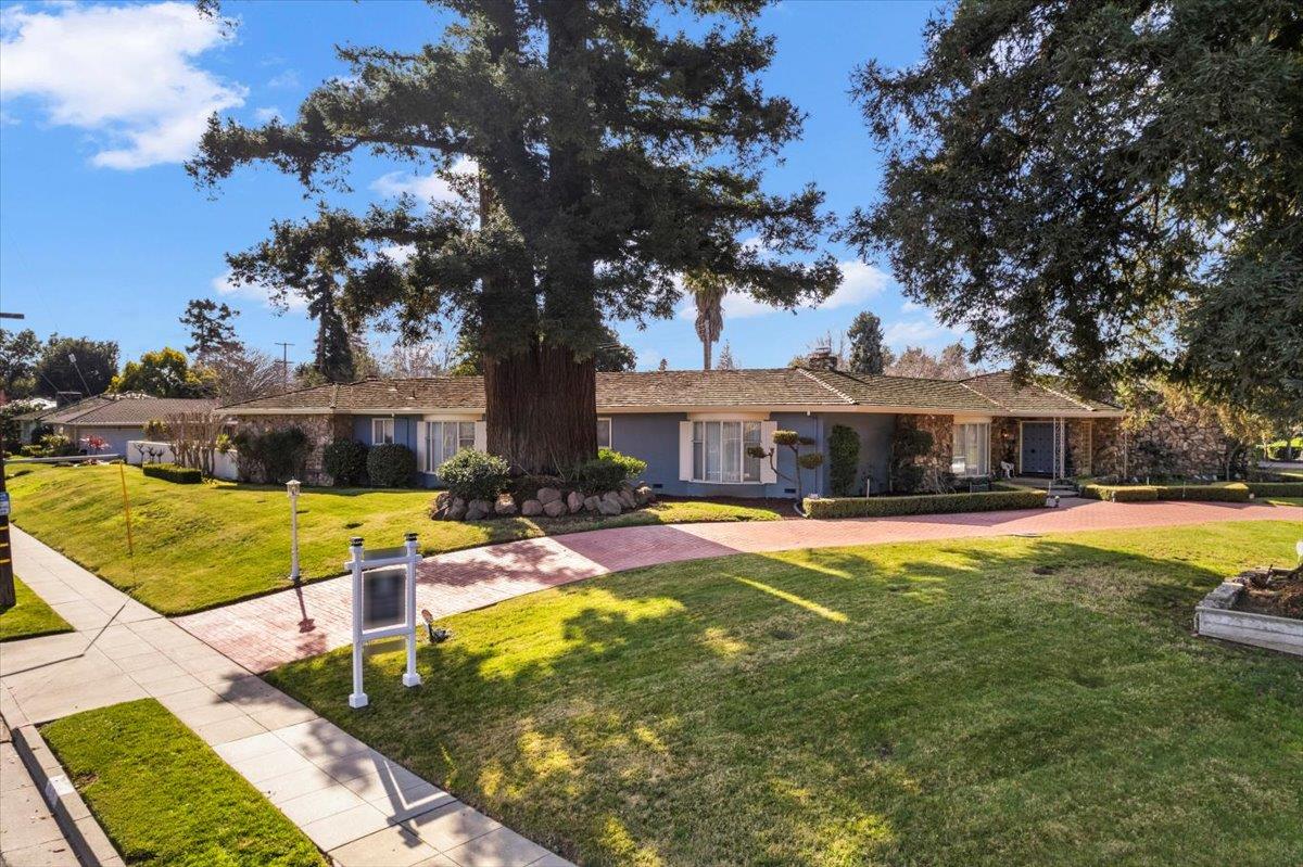 a view of a house with swimming pool and sitting area