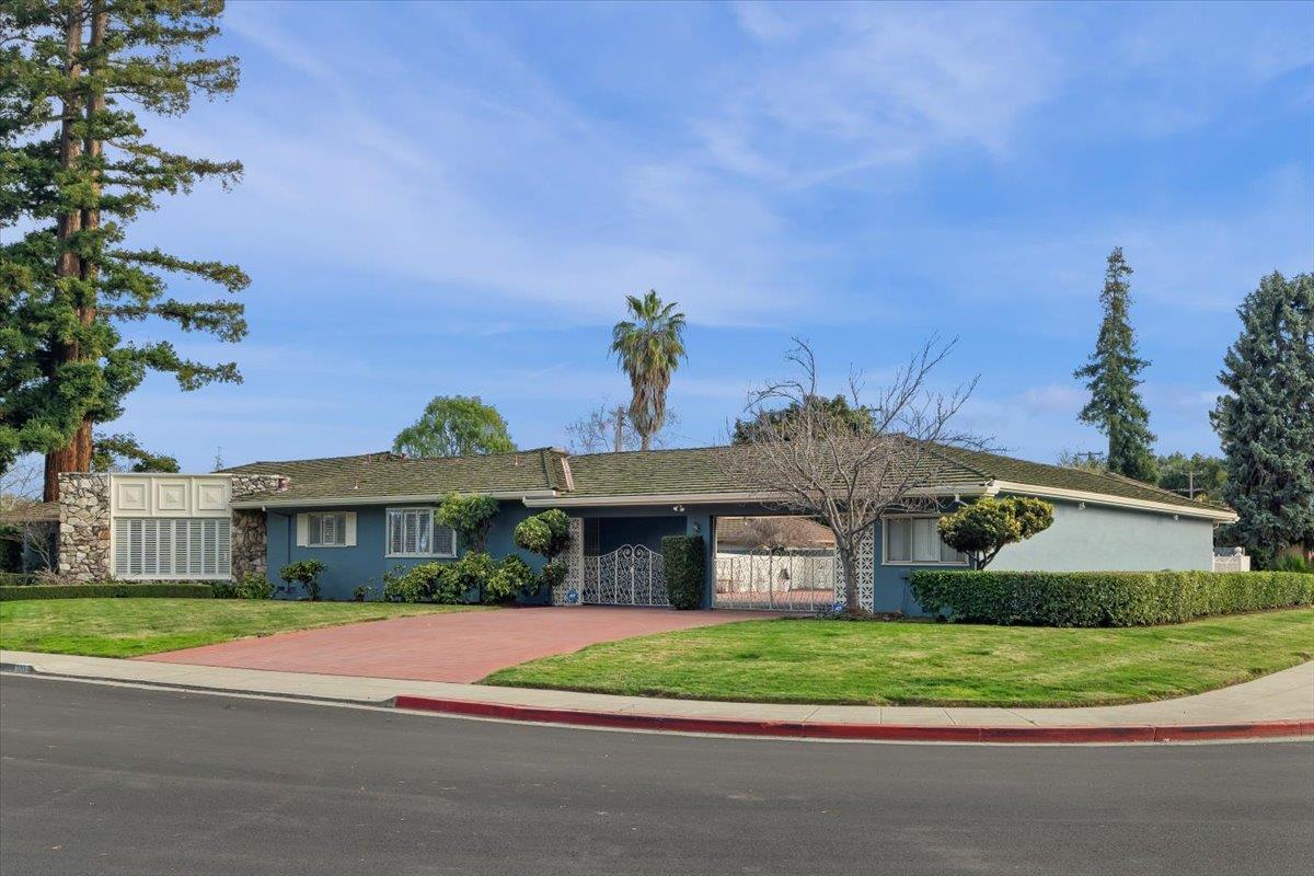 1215 Camino Ramon San Jose, CA 95125 - Photo 13 of 76 a front view of a house with a yard and garage