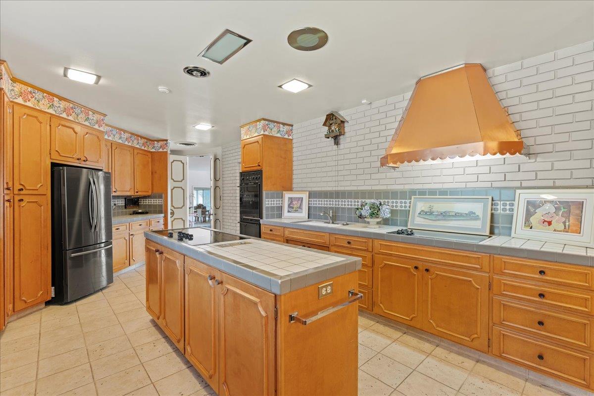 1215 Camino Ramon San Jose, CA 95125 - Photo 35 of 76 a kitchen with stainless steel appliances granite countertop a sink and dishwasher a refrigerator with wooden cabinets