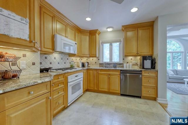 230 Pinelynn Road Glen Rock, NJ 07452 - Photo 8 of 19 a kitchen with granite countertop a sink stove cabinets and refrigerator