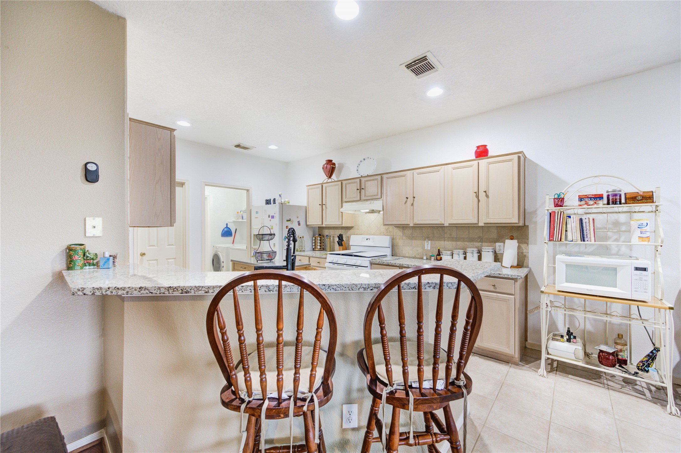 16730 Spring Barker Drive Cypress, TX 77429 - Photo 30 of 50 a very nice looking kitchen with a table and chairs