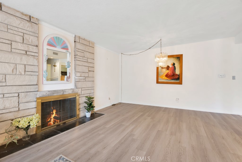 14024 Tyler Street Sylmar, CA 91342 - Photo 11 of 50 an empty room with windows fireplace and wooden floor