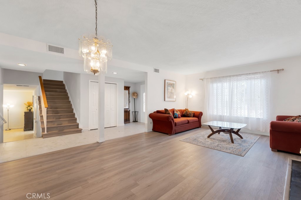 14024 Tyler Street Sylmar, CA 91342 - Photo 12 of 50 a living room with furniture chandelier and a window