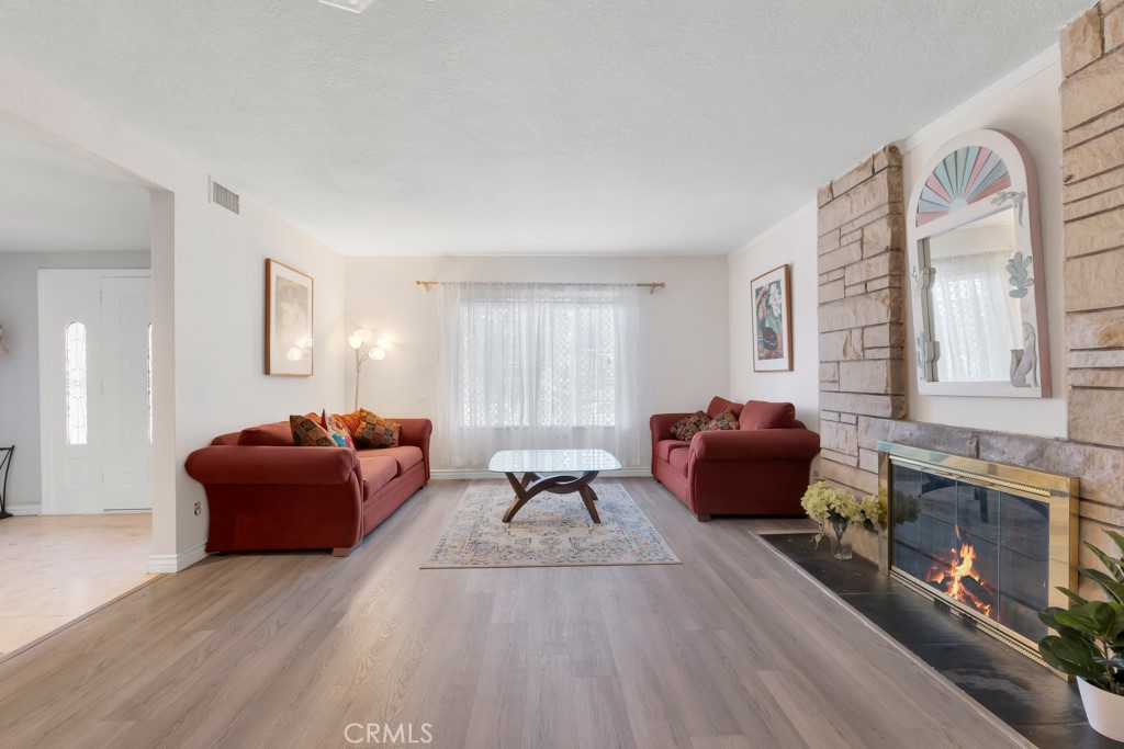 14024 Tyler Street Sylmar, CA 91342 - Photo 13 of 50 a living room with furniture and a fireplace