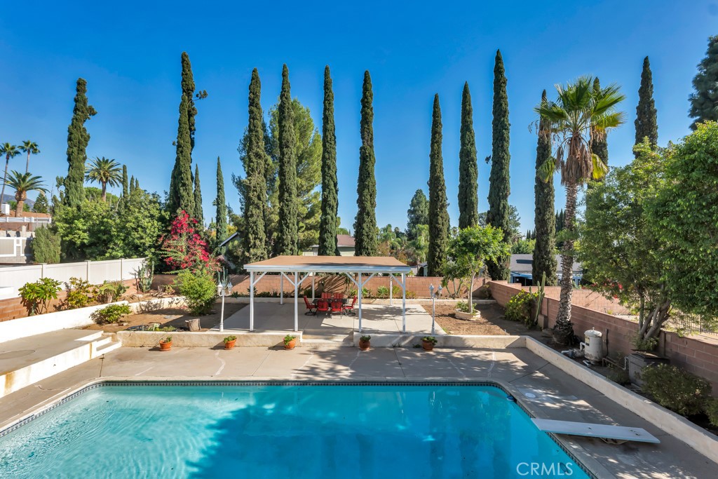 14024 Tyler Street Sylmar, CA 91342 - Photo 29 of 50 a view of a swimming pool with a patio and a yard