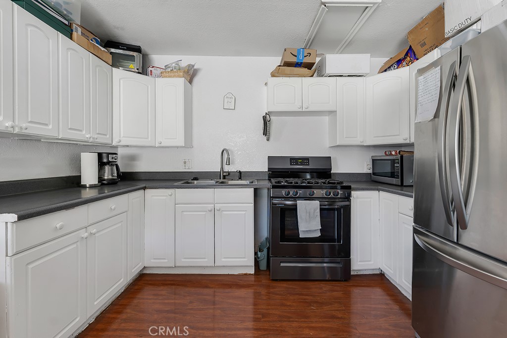 14024 Tyler Street Sylmar, CA 91342 - Photo 38 of 50 a kitchen with stainless steel appliances white cabinets and a sink